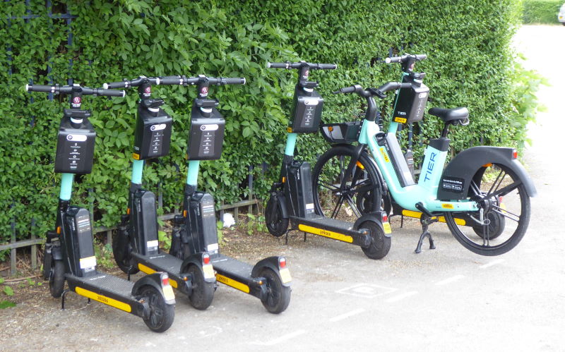 A row of e-scooters and an e-bike
