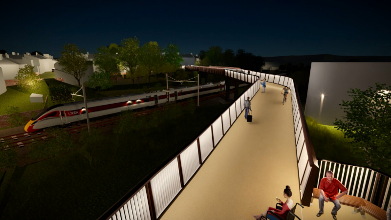 A photorealistic night rendering of the proposed bridge. The bridge structure is highlighted by vertical light strips integrated into the railings, brightly illuminating the walkway surface. Activity includes cyclists and pedestrians walking with luggage. In the foreground, people sit on benches in a resting area. Below, a red and LNER passenger train passes along the tracks.